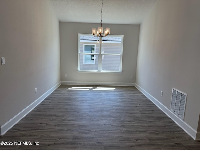 8284 Helmsley Blvd, Jacksonville, FL 32219 - unfurnished dining area with visible vents, a notable chandelier, dark wood finished floors, and a textured ceiling