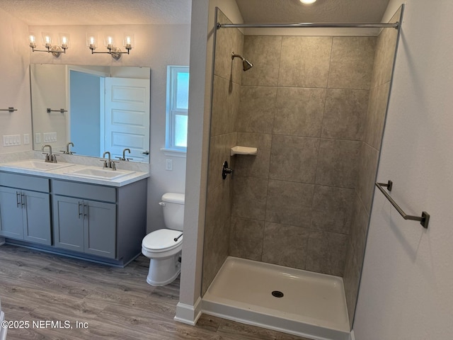 8284 Helmsley Blvd, Jacksonville, FL 32219 - full bath featuring tiled shower, toilet, wood finished floors, and a sink