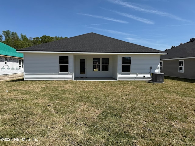 8284 Helmsley Blvd, Jacksonville, FL 32219 - back of house with a patio area, a lawn, central AC, and a shingled roof