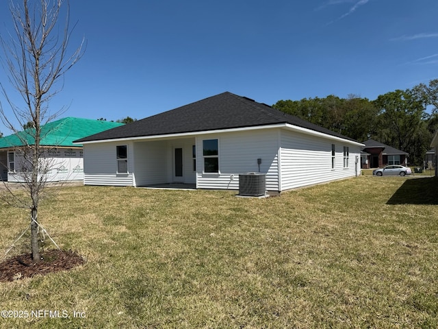 8284 Helmsley Blvd, Jacksonville, FL 32219 - back of house with central air condition unit and a yard