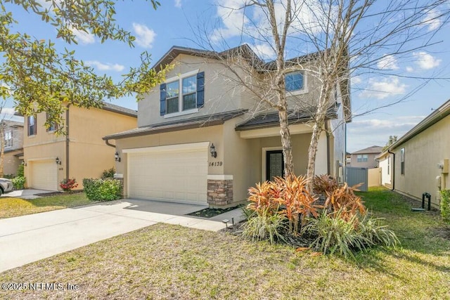 view of front of property with a garage and a front yard