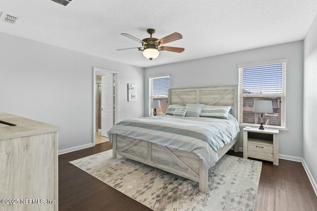 bedroom featuring dark wood-type flooring and ceiling fan