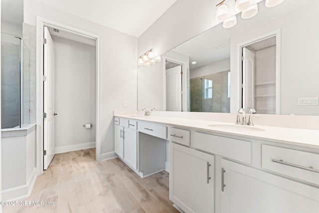 bathroom with vanity, hardwood / wood-style floors, and an enclosed shower