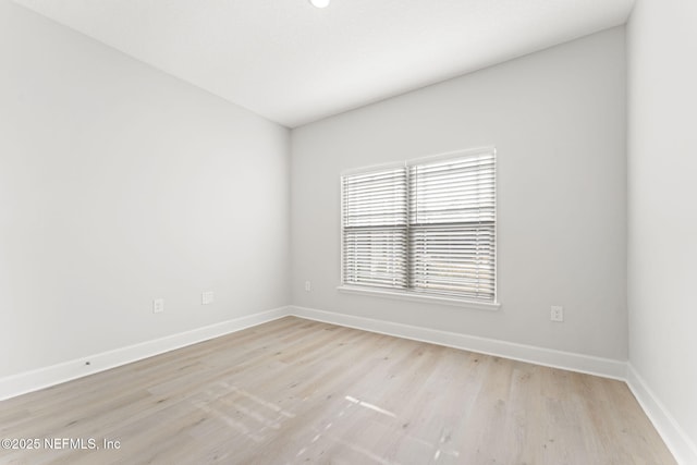 unfurnished room with light hardwood / wood-style floors