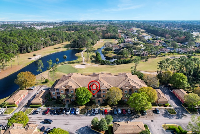 aerial view with a residential view, view of golf course, and a water view