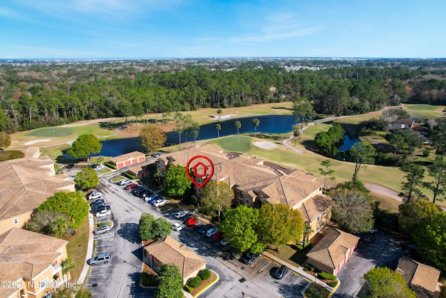 birds eye view of property featuring a water view, a wooded view, and golf course view