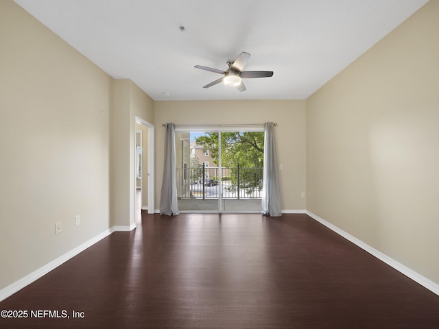 unfurnished room featuring ceiling fan, wood finished floors, and baseboards