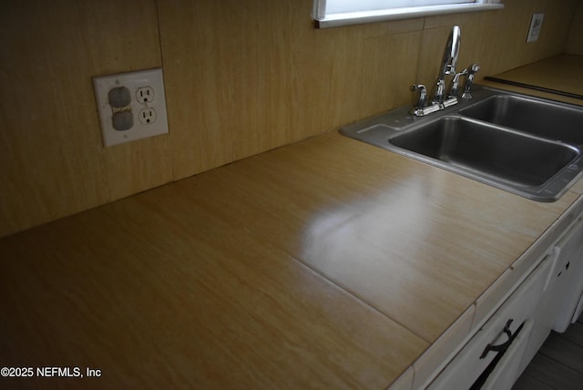 interior space with sink and white cabinets