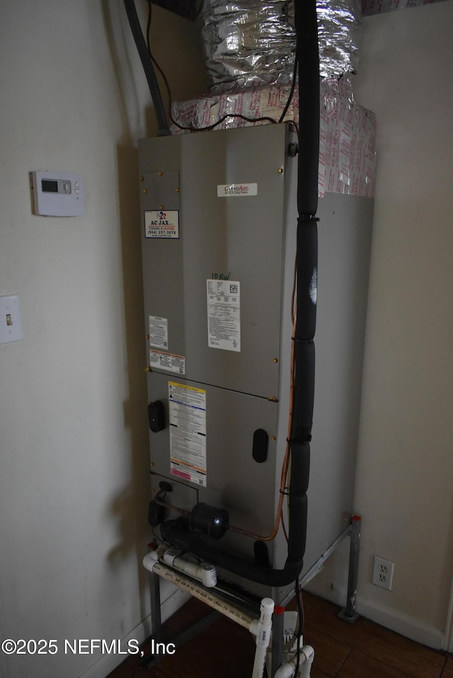 utility room featuring heating unit