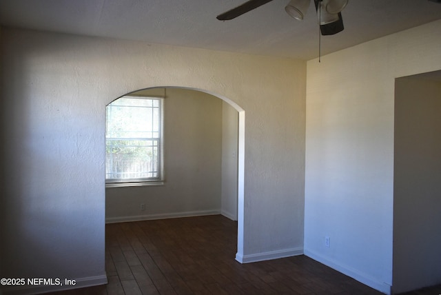 unfurnished room with dark wood-type flooring and ceiling fan