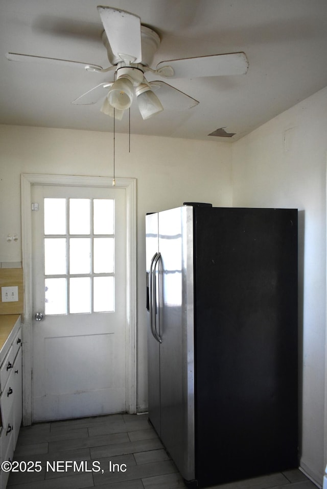 kitchen featuring white cabinetry, stainless steel refrigerator with ice dispenser, and ceiling fan