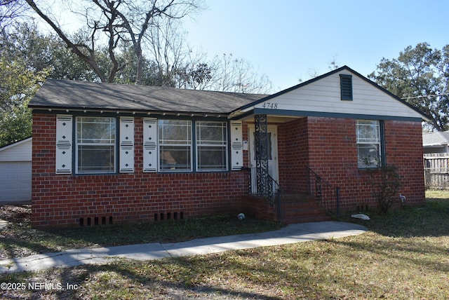 view of front of property with a garage and a front lawn