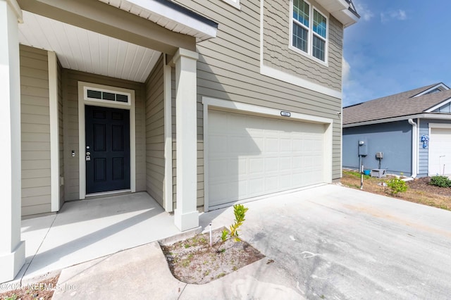 doorway to property with a garage