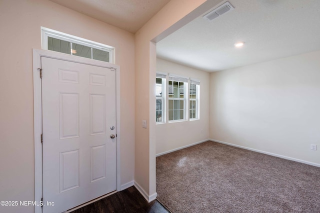 foyer with dark carpet