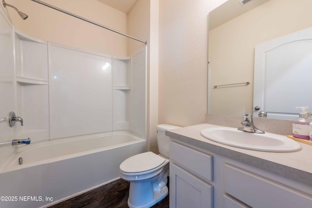 full bathroom featuring vanity, hardwood / wood-style flooring, bathing tub / shower combination, and toilet