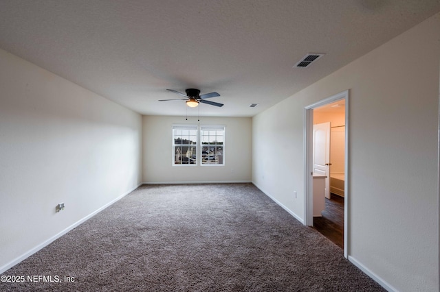 spare room with dark carpet, a textured ceiling, and ceiling fan