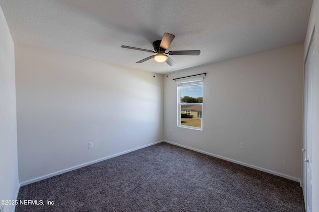 carpeted empty room with ceiling fan and a textured ceiling