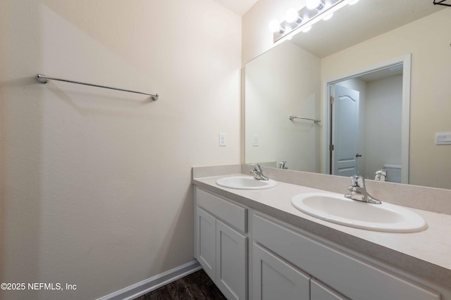 bathroom featuring vanity, toilet, and hardwood / wood-style floors