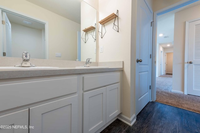 bathroom with hardwood / wood-style flooring and vanity