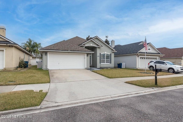 single story home featuring a garage and a front lawn