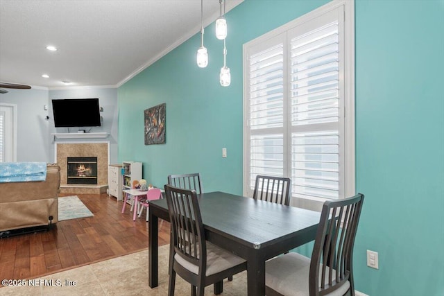 tiled dining room with ornamental molding and ceiling fan