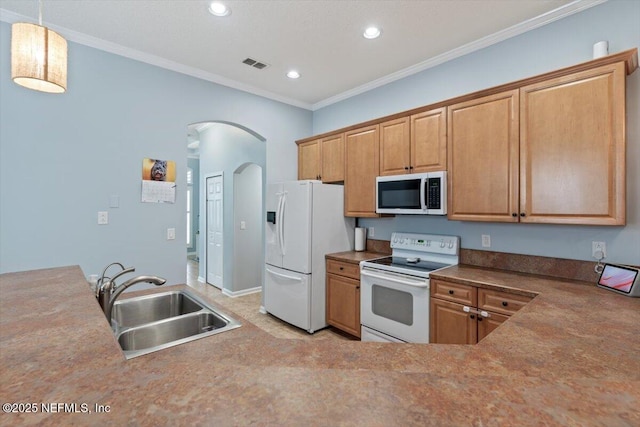 kitchen with ornamental molding, sink, pendant lighting, and white appliances