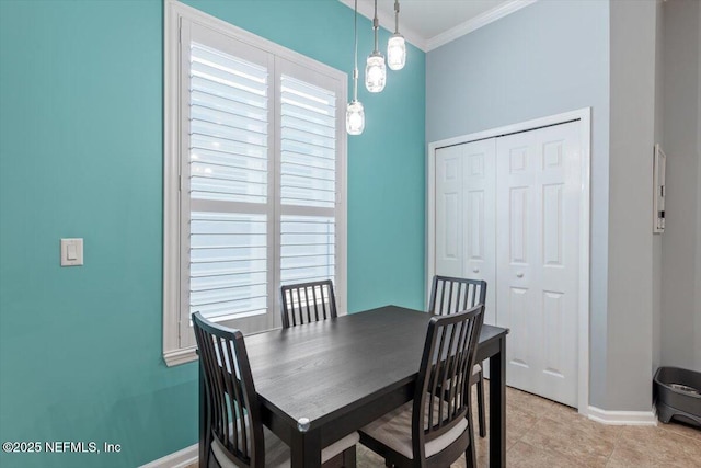 dining room with light tile patterned floors and crown molding