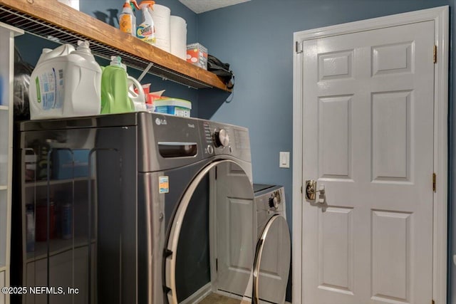 washroom with washing machine and dryer