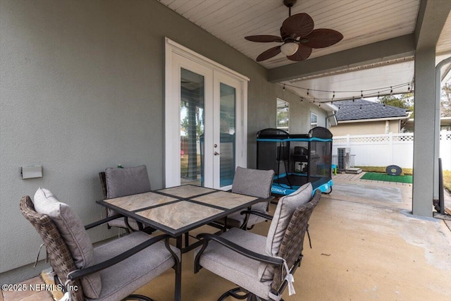 view of patio / terrace featuring ceiling fan and french doors