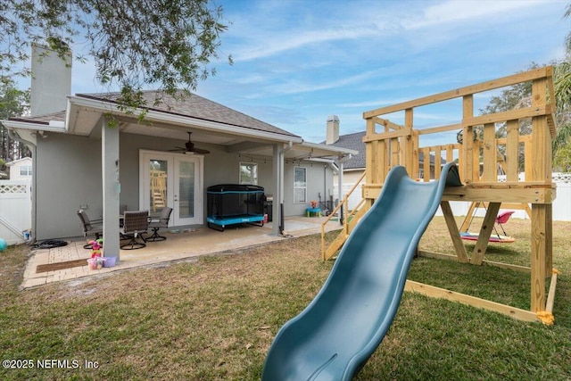 view of jungle gym featuring a yard, a patio, and ceiling fan