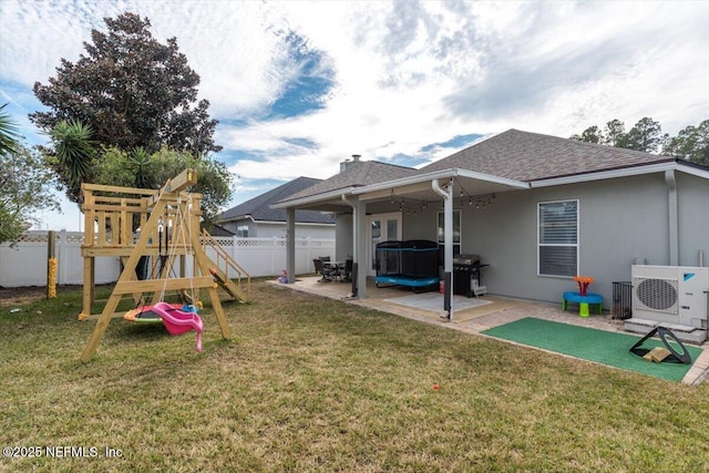 exterior space with a yard, a patio area, ac unit, and a playground