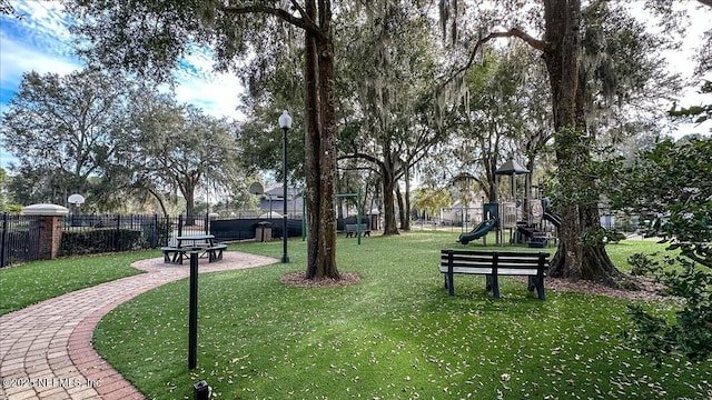 surrounding community with a playground and a lawn