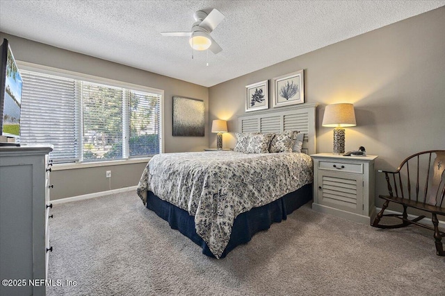 bedroom featuring ceiling fan, a textured ceiling, and carpet flooring