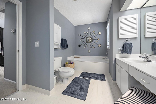 bathroom featuring a washtub, vanity, a textured ceiling, tile patterned floors, and toilet