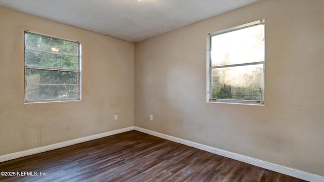 empty room featuring dark hardwood / wood-style flooring