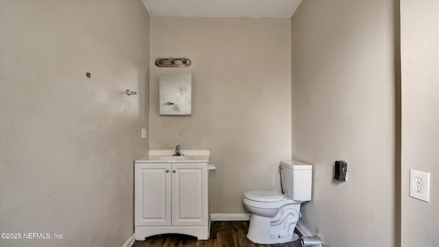 bathroom featuring vanity, toilet, and hardwood / wood-style floors