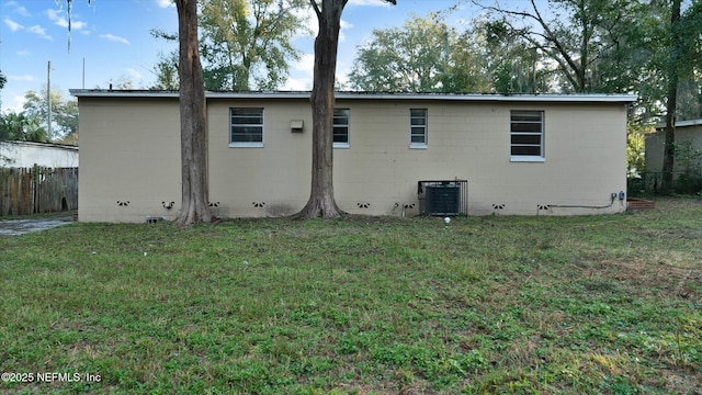 back of property featuring a yard and central AC unit