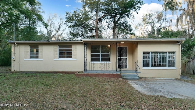 ranch-style home featuring a front lawn and a porch