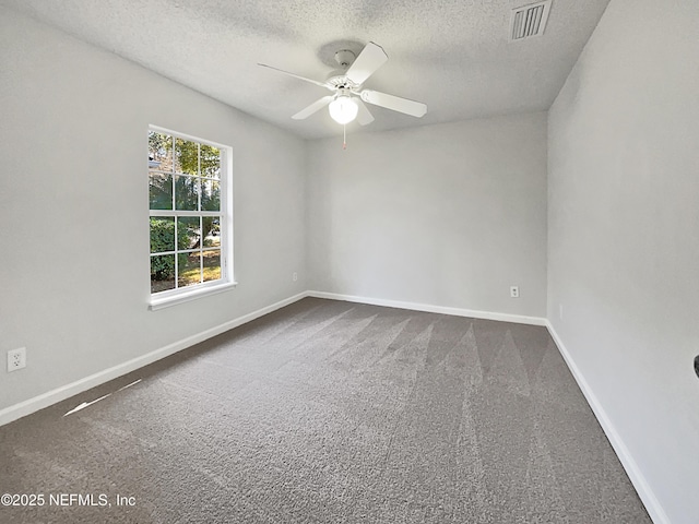 carpeted spare room with ceiling fan and a textured ceiling