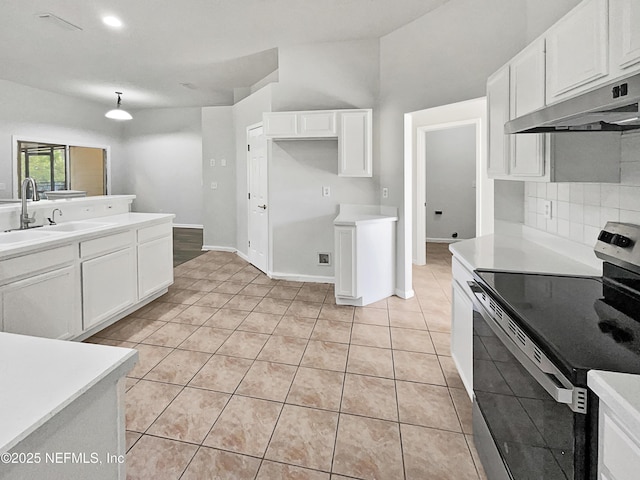 kitchen featuring sink, light tile patterned floors, electric stove, decorative backsplash, and white cabinets