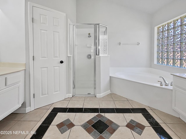 bathroom featuring tile patterned flooring, plus walk in shower, and vanity