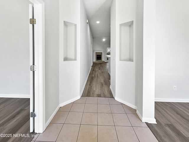 hall with light tile patterned floors