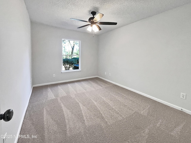 carpeted empty room with ceiling fan and a textured ceiling