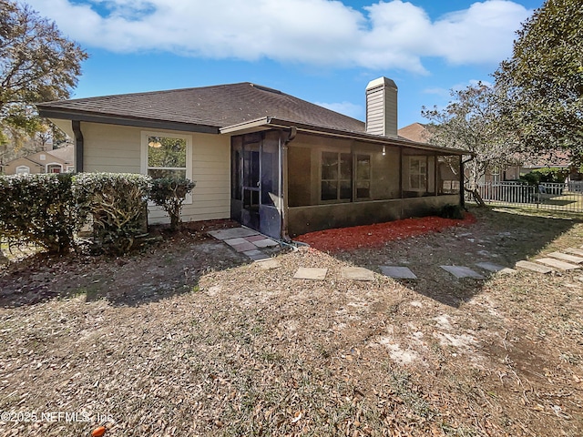 rear view of house with a sunroom