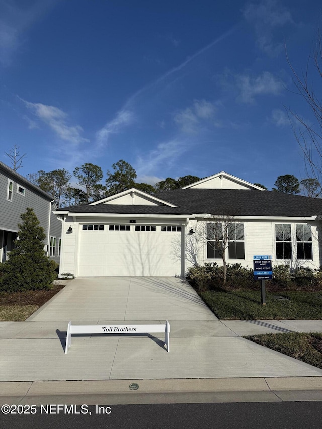 view of front of home featuring concrete driveway and an attached garage