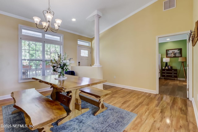 94202 Christopher Ln, Fernandina Beach, FL 32034 - dining room featuring ornate columns, ornamental molding, and light hardwood / wood-style flooring