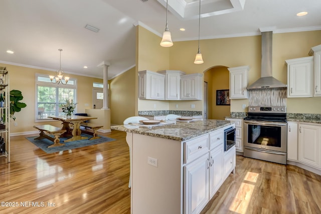 94202 Christopher Ln, Fernandina Beach, FL 32034 - kitchen with wall chimney exhaust hood, white cabinetry, stainless steel appliances, and pendant lighting