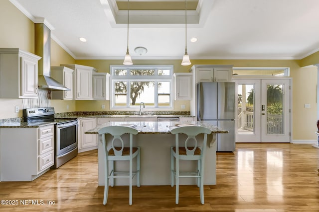94202 Christopher Ln, Fernandina Beach, FL 32034 - kitchen featuring pendant lighting, appliances with stainless steel finishes, white cabinets, a kitchen island, and dark stone counters