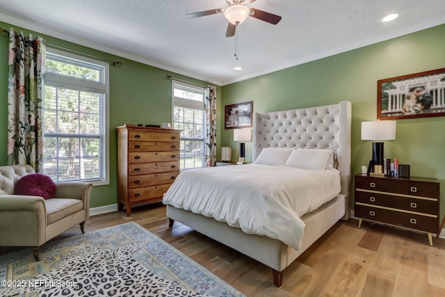 94202 Christopher Ln, Fernandina Beach, FL 32034 - bedroom with crown molding, a textured ceiling, light hardwood / wood-style flooring, and ceiling fan