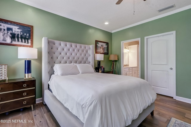 94202 Christopher Ln, Fernandina Beach, FL 32034 - bedroom featuring crown molding, connected bathroom, hardwood / wood-style flooring, and ceiling fan